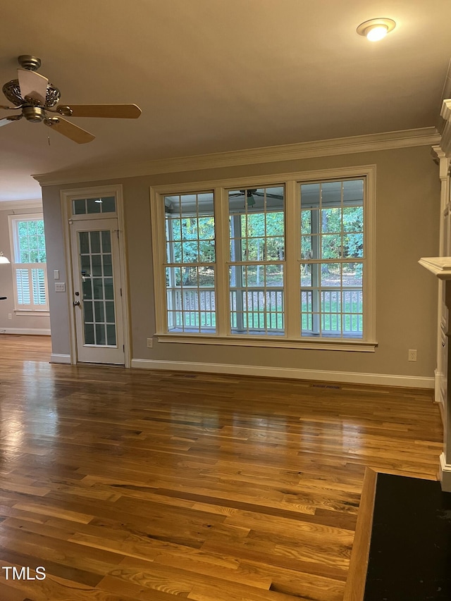 126 Riverglade Dr, Clayton, NC 27527 - unfurnished living room featuring ornamental molding, ceiling fan, wood finished floors, and baseboards