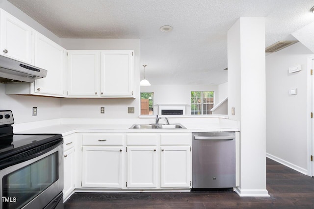 105 Sir Richard Ln, Chapel Hill, NC 27517 - kitchen with appliances with stainless steel finishes, a sink, extractor fan, a textured ceiling, and light countertops
