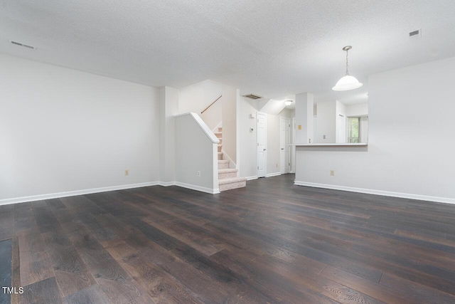 105 Sir Richard Ln, Chapel Hill, NC 27517 - unfurnished living room featuring dark wood-style floors, stairs, baseboards, and a textured ceiling