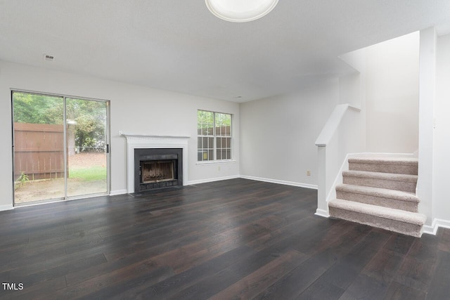 105 Sir Richard Ln, Chapel Hill, NC 27517 - unfurnished living room with dark wood-style floors, healthy amount of natural light, stairway, and baseboards
