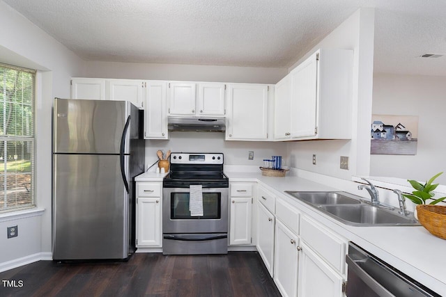 105 Sir Richard Ln, Chapel Hill, NC 27517 - kitchen featuring stainless steel appliances, under cabinet range hood, dark wood-type flooring, light countertops, and white cabinets