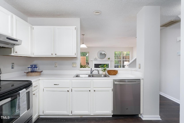 105 Sir Richard Ln, Chapel Hill, NC 27517 - kitchen featuring appliances with stainless steel finishes, light countertops, white cabinets, a textured ceiling, and dark wood finished floors