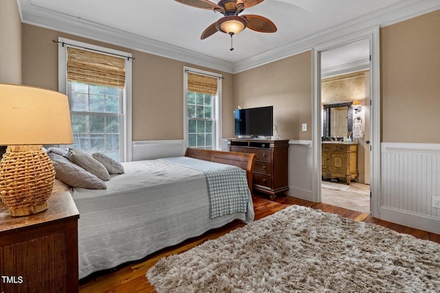 4720 Yates Mill Pond Rd, Raleigh, NC 27606 - bedroom with ornamental molding, a wainscoted wall, wood finished floors, ensuite bathroom, and a ceiling fan