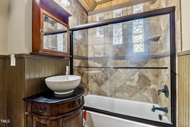 4720 Yates Mill Pond Rd, Raleigh, NC 27606 - full bathroom featuring combined bath / shower with glass door, vanity, and wainscoting