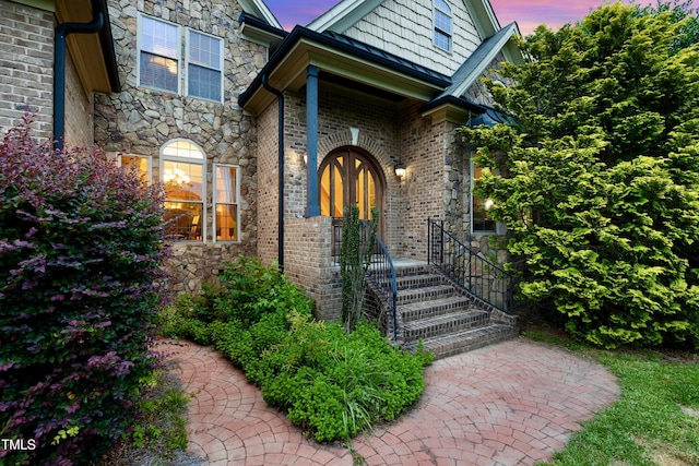 4720 Yates Mill Pond Rd, Raleigh, NC 27606 - exterior entry at dusk featuring stone siding and brick siding