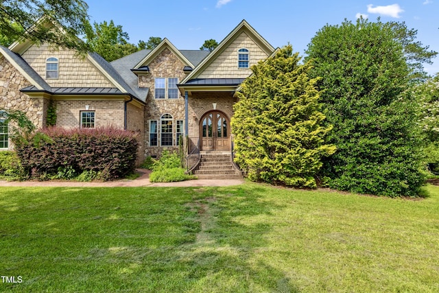 4720 Yates Mill Pond Rd, Raleigh, NC 27606 - view of front facade featuring a front yard, a standing seam roof, stone siding, and french doors