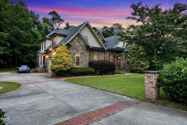 4720 Yates Mill Pond Rd, Raleigh, NC 27606 - craftsman house with stone siding, concrete driveway, a front lawn, and a standing seam roof