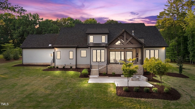 15517 Possum Track Rd, Raleigh, NC 27614 - back of house at dusk with a patio, a yard, and roof with shingles