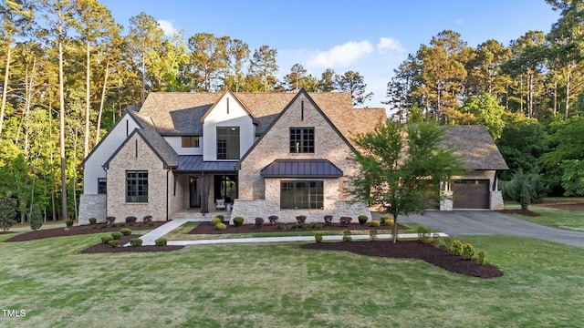 15517 Possum Track Rd, Raleigh, NC 27614 - view of front of property featuring a standing seam roof, a front yard, an attached garage, covered porch, and asphalt driveway