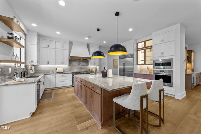 15517 Possum Track Rd, Raleigh, NC 27614 - kitchen with high quality appliances, custom range hood, open shelves, a sink, and decorative backsplash