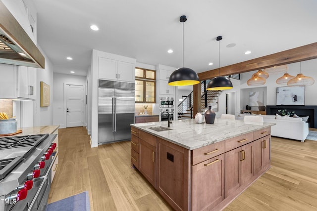 15517 Possum Track Rd, Raleigh, NC 27614 - kitchen featuring high quality appliances, premium range hood, light wood-type flooring, a sink, and recessed lighting