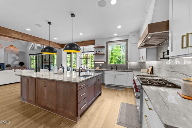 15517 Possum Track Rd, Raleigh, NC 27614 - kitchen featuring stainless steel appliances, a sink, light wood finished floors, decorative backsplash, and light stone counters