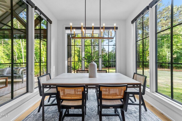15517 Possum Track Rd, Raleigh, NC 27614 - sunroom featuring a chandelier, plenty of natural light, and french doors