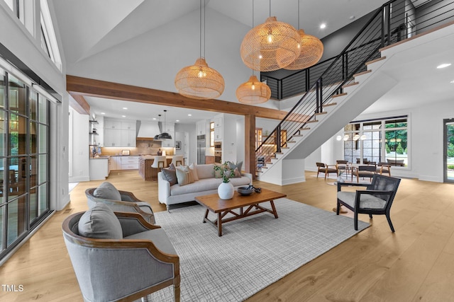 15517 Possum Track Rd, Raleigh, NC 27614 - living room with high vaulted ceiling, stairs, light wood finished floors, recessed lighting, and baseboards