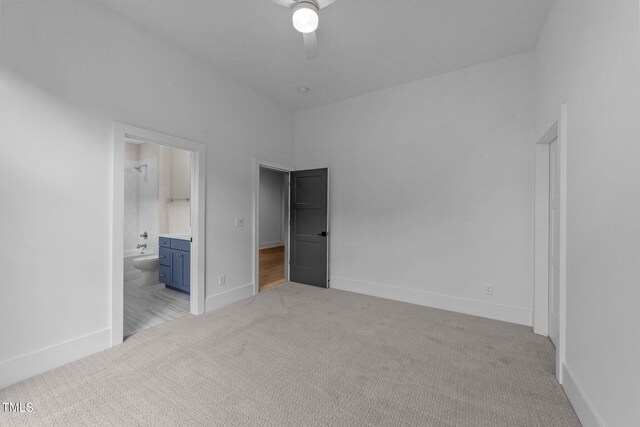 15517 Possum Track Rd, Raleigh, NC 27614 - unfurnished bedroom featuring light colored carpet, ensuite bathroom, baseboards, and a ceiling fan