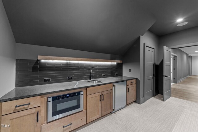 15517 Possum Track Rd, Raleigh, NC 27614 - kitchen with backsplash, a sink, dark stone counters, light brown cabinetry, and fridge