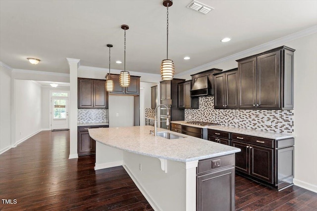 125 Durban Meadow Dr, Holly Springs, NC 27540 - kitchen with a sink, premium range hood, dark wood finished floors, dark brown cabinetry, and ornamental molding