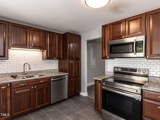 102 Sanair Ct, Apex, NC 27502 - kitchen featuring appliances with stainless steel finishes, a sink, backsplash, and baseboards