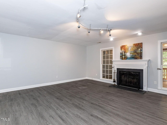 102 Sanair Ct, Apex, NC 27502 - unfurnished living room with dark wood-style flooring, a fireplace with raised hearth, and baseboards