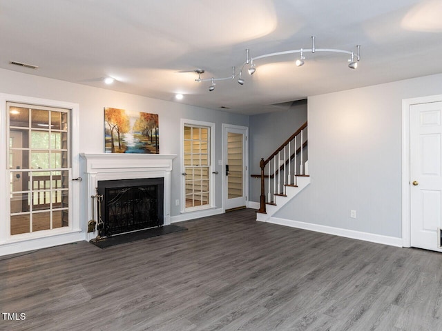102 Sanair Ct, Apex, NC 27502 - unfurnished living room featuring wood finished floors, stairway, baseboards, and a fireplace with raised hearth