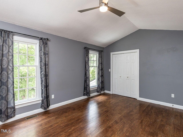102 Sanair Ct, Apex, NC 27502 - spare room featuring a ceiling fan, lofted ceiling, wood finished floors, baseboards, and a textured ceiling