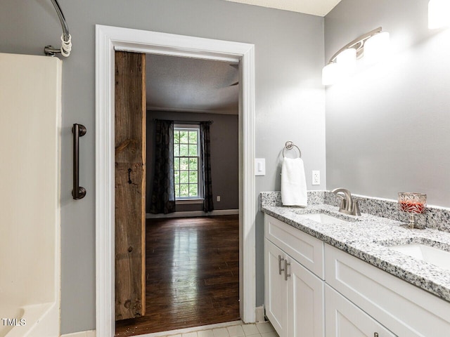 102 Sanair Ct, Apex, NC 27502 - bathroom featuring double vanity, baseboards, and wood finished floors