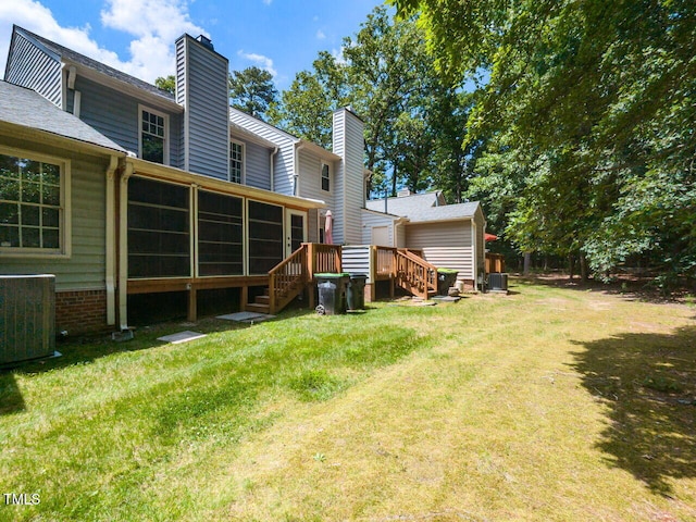 102 Sanair Ct, Apex, NC 27502 - view of grassy yard featuring a sunroom, central AC unit, and a deck