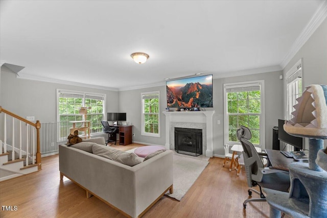 2750 Michelle Ct, Creedmoor, NC 27522 - living room with healthy amount of natural light, ornamental molding, a fireplace with flush hearth, stairway, and light wood-type flooring