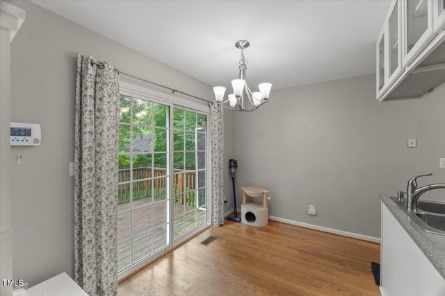 2750 Michelle Ct, Creedmoor, NC 27522 - unfurnished dining area featuring a chandelier and wood finished floors