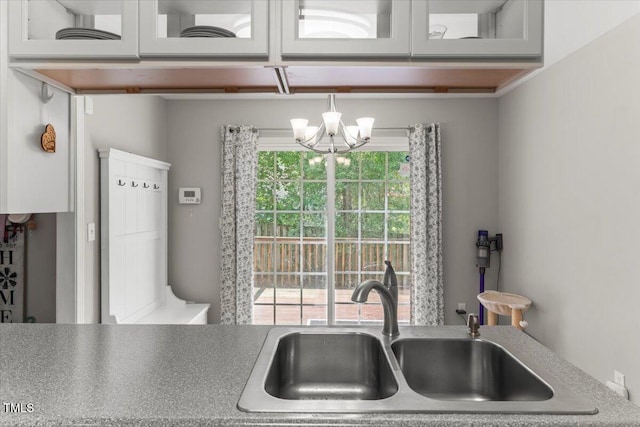 2750 Michelle Ct, Creedmoor, NC 27522 - kitchen with a chandelier, glass insert cabinets, white cabinets, and light countertops