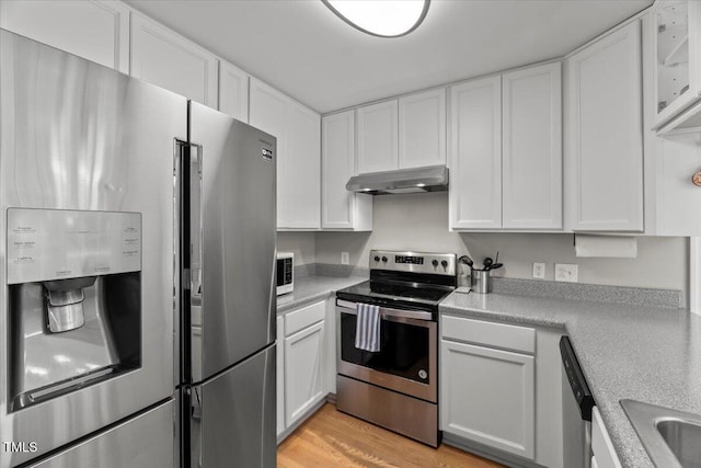 2750 Michelle Ct, Creedmoor, NC 27522 - kitchen featuring stainless steel appliances, under cabinet range hood, white cabinets, and light countertops