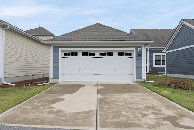 6313 Kayton St, Raleigh, NC 27616 - view of front facade with an attached garage, central AC, driveway, and a shingled roof