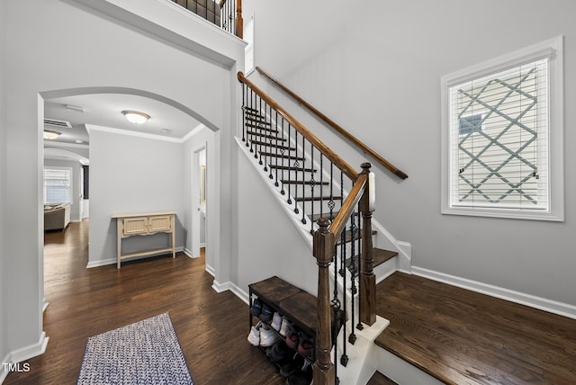 6313 Kayton St, Raleigh, NC 27616 - stairway with arched walkways, crown molding, baseboards, and wood finished floors