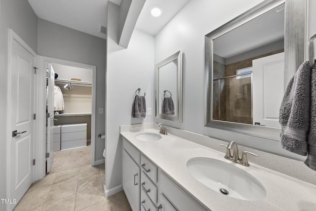 6313 Kayton St, Raleigh, NC 27616 - full bathroom featuring double vanity, a stall shower, a spacious closet, toilet, and tile patterned flooring