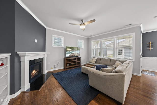 6313 Kayton St, Raleigh, NC 27616 - living area with crown molding, wood finished floors, ceiling fan, baseboards, and a glass covered fireplace