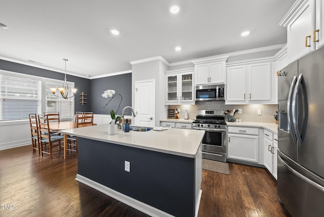 6313 Kayton St, Raleigh, NC 27616 - kitchen with stainless steel appliances, crown molding, light countertops, white cabinetry, and a chandelier