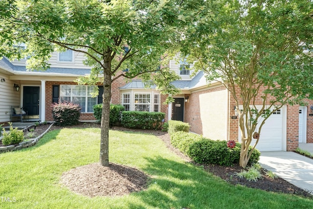 11217 Maplecroft Ct, Raleigh, NC 27617 - view of front facade featuring a front lawn, a garage, brick siding, and driveway