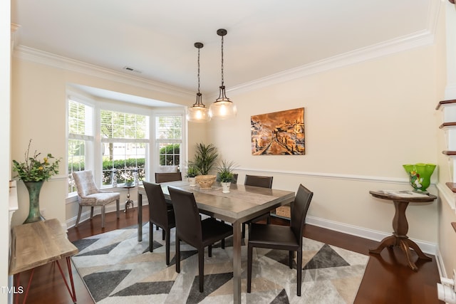 11217 Maplecroft Ct, Raleigh, NC 27617 - dining area with crown molding, wood finished floors, and baseboards