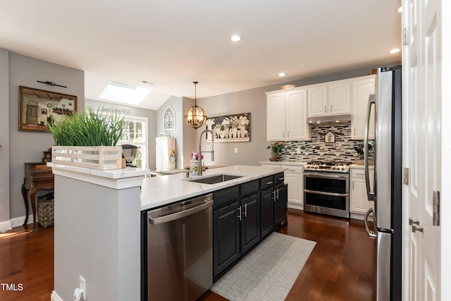 11217 Maplecroft Ct, Raleigh, NC 27617 - kitchen with appliances with stainless steel finishes, a sink, white cabinetry, an island with sink, and tasteful backsplash