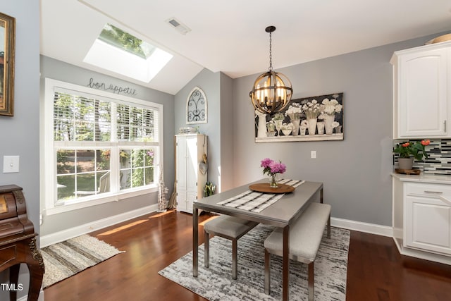 11217 Maplecroft Ct, Raleigh, NC 27617 - dining space featuring a skylight, dark wood finished floors, plenty of natural light, and a chandelier