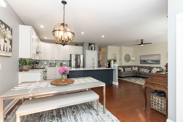 11217 Maplecroft Ct, Raleigh, NC 27617 - dining room featuring dark wood-type flooring, a chandelier, a ceiling fan, and recessed lighting