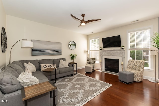 11217 Maplecroft Ct, Raleigh, NC 27617 - living room with wood finished floors, ceiling fan, a fireplace with flush hearth, and baseboards