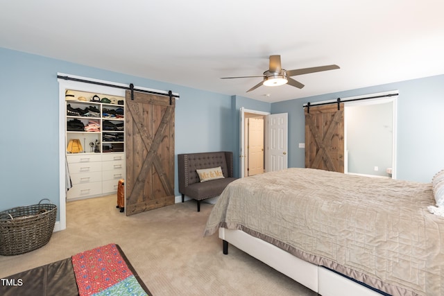 11217 Maplecroft Ct, Raleigh, NC 27617 - bedroom featuring a barn door, carpet floors, a walk in closet, ceiling fan, and a closet