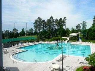11217 Maplecroft Ct, Raleigh, NC 27617 - community pool featuring a water slide, a patio area, and view of scattered trees