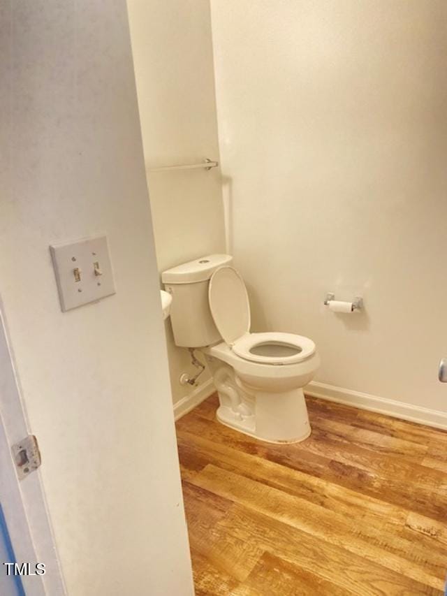 3207 Geary Trl, Raleigh, NC 27610 - bathroom featuring toilet, wood finished floors, and baseboards