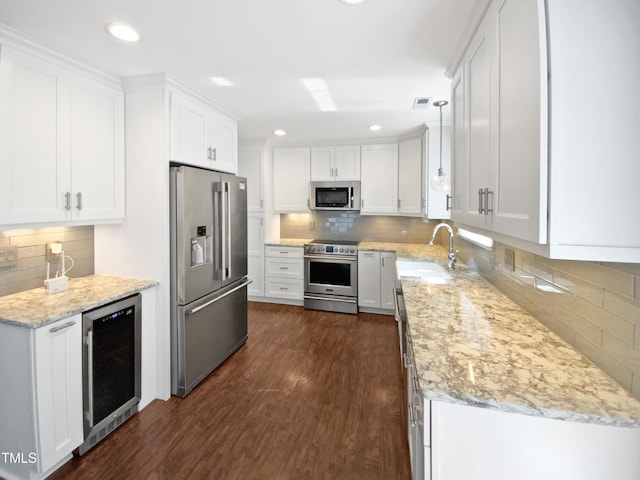 117 Brierridge Dr, Apex, NC 27502 - kitchen with appliances with stainless steel finishes, beverage cooler, a sink, decorative backsplash, and recessed lighting