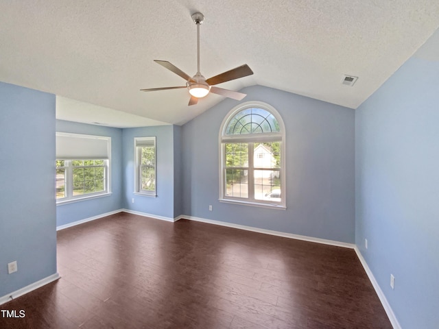 117 Brierridge Dr, Apex, NC 27502 - spare room with plenty of natural light, a ceiling fan, dark wood-style flooring, vaulted ceiling, and a textured ceiling