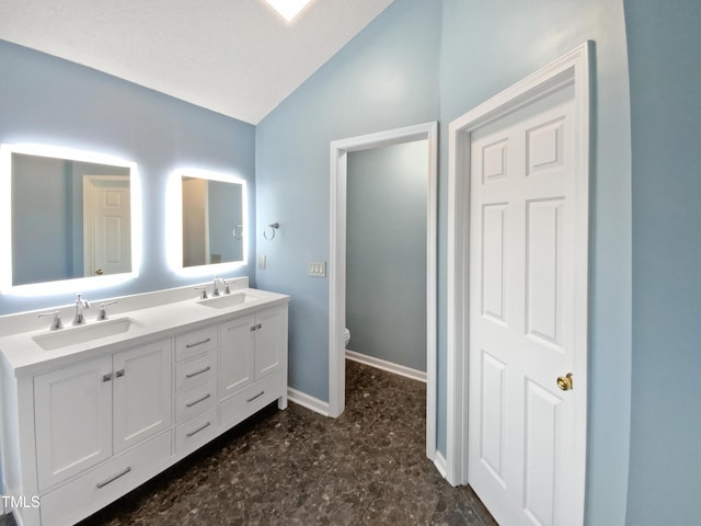 117 Brierridge Dr, Apex, NC 27502 - bathroom featuring vaulted ceiling, double vanity, baseboards, and toilet
