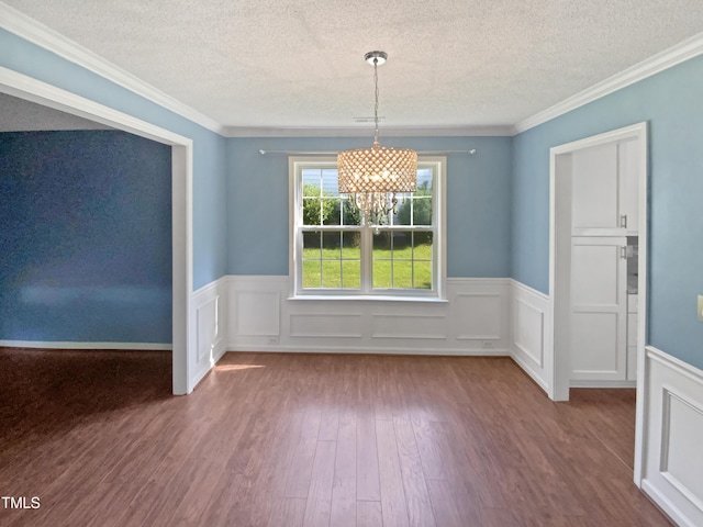 117 Brierridge Dr, Apex, NC 27502 - unfurnished dining area featuring a textured ceiling, a chandelier, wood finished floors, a wainscoted wall, and crown molding