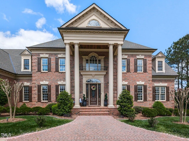 5768 Cavanaugh Dr, Raleigh, NC 27614 - greek revival house with a balcony, brick siding, and roof with shingles
